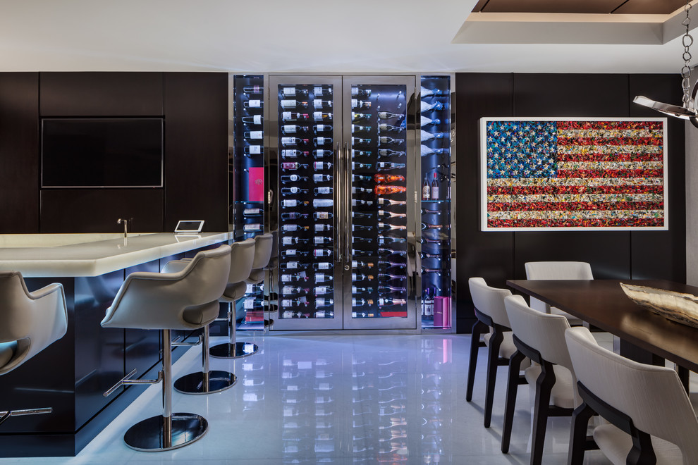 This is an example of a large modern seated home bar in Miami with flat-panel cabinets, dark wood cabinets, solid surface benchtops, marble floors and grey floor.