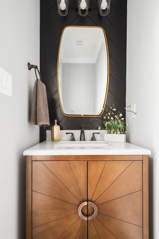Photo of a small contemporary powder room in Raleigh with flat-panel cabinets, medium wood cabinets, white walls, an undermount sink and white benchtops.