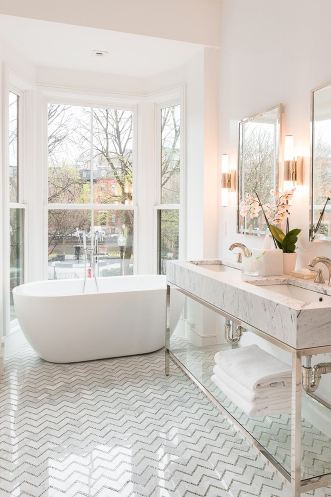 Design ideas for a transitional bathroom in Boston with an undermount sink, open cabinets, a freestanding tub, white tile, white walls and marble floors.