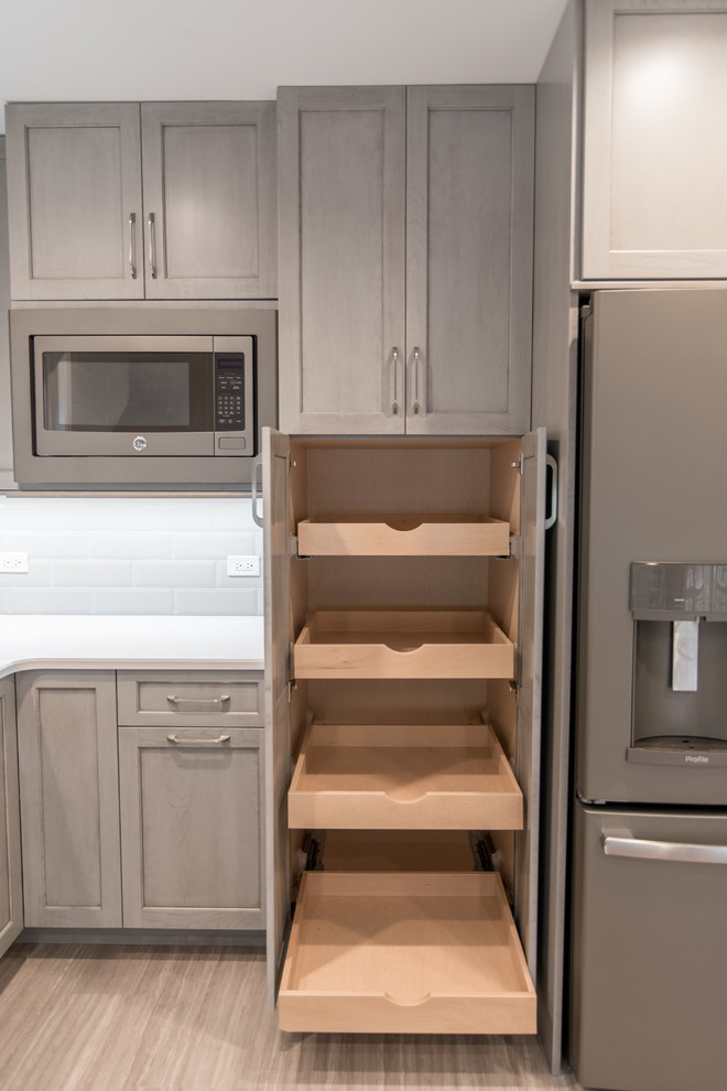 Mid-sized transitional u-shaped vinyl floor and gray floor enclosed kitchen photo in Chicago with an undermount sink, recessed-panel cabinets, gray cabinets, quartzite countertops, gray backsplash, subway tile backsplash and stainless steel appliances