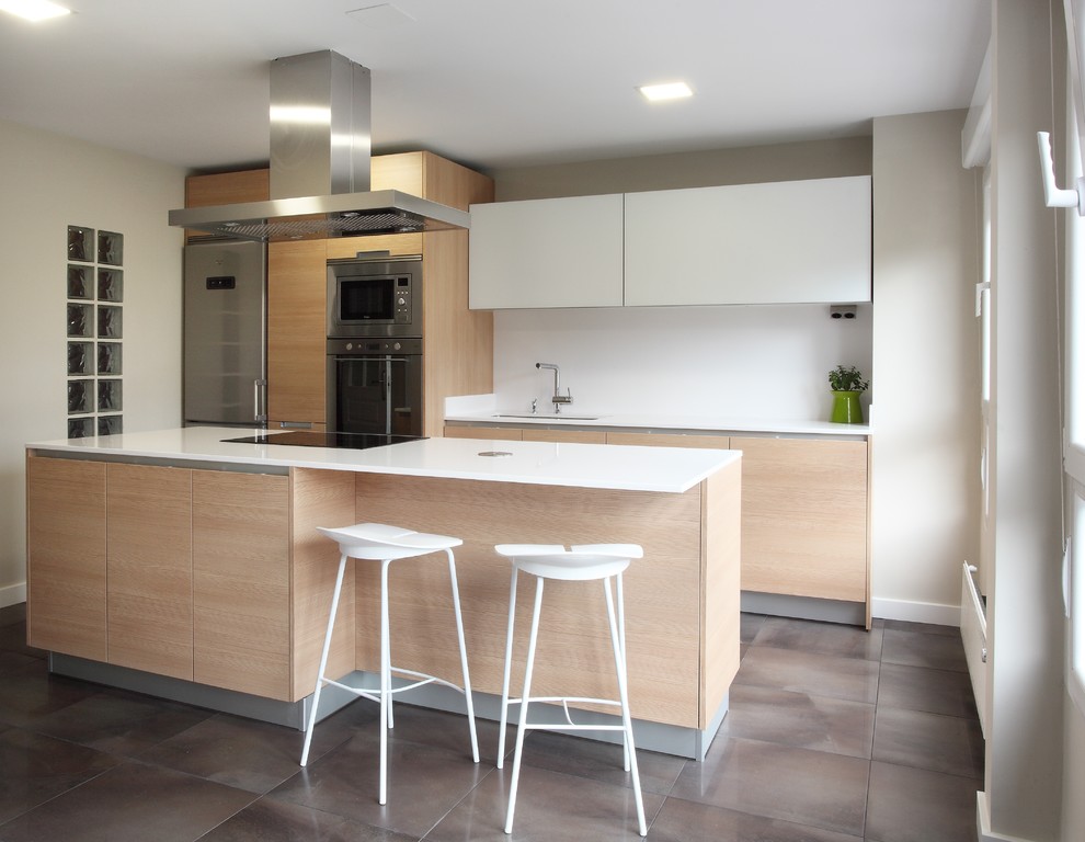 Photo of a mid-sized scandinavian single-wall open plan kitchen in Other with flat-panel cabinets, light wood cabinets, white splashback, stainless steel appliances and with island.