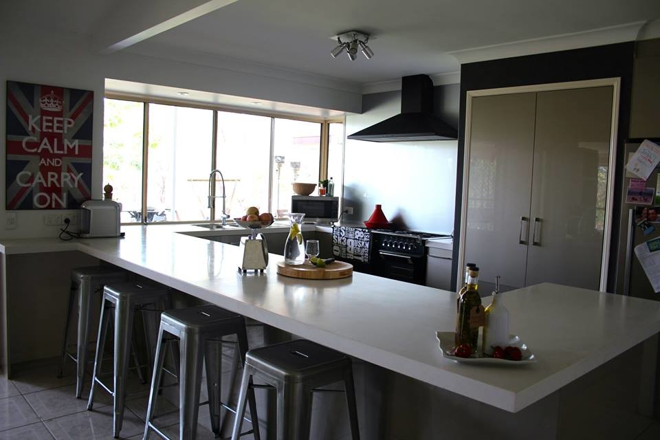 Design ideas for a large contemporary u-shaped open plan kitchen in Brisbane with a double-bowl sink, glass-front cabinets, beige cabinets, granite benchtops, metallic splashback, glass sheet splashback, stainless steel appliances, ceramic floors and no island.