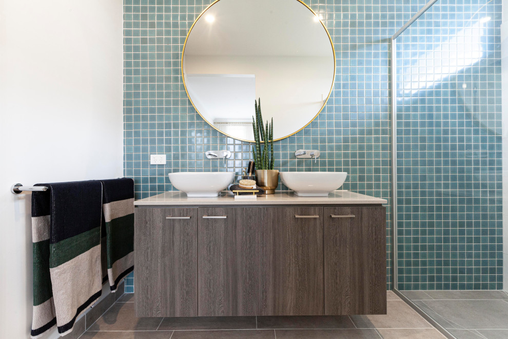 Photo of a contemporary bathroom in Melbourne with brown cabinets, a double shower, blue tile, ceramic tile, white walls, ceramic floors, engineered quartz benchtops, beige floor, a hinged shower door, beige benchtops and a double vanity.