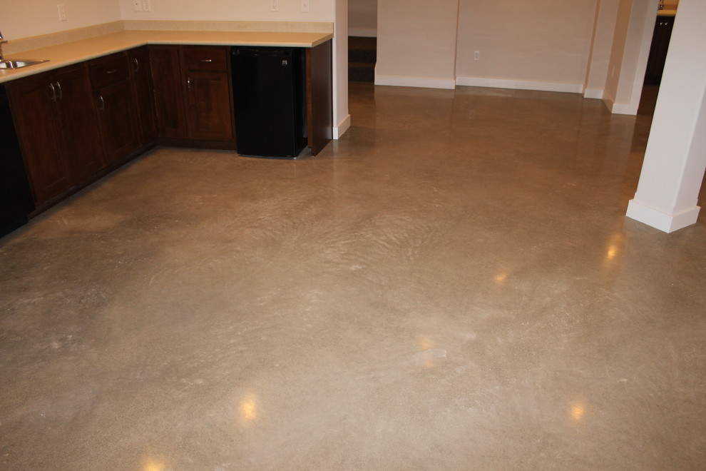 This is an example of a mid-sized walk-out basement in Other with concrete floors.