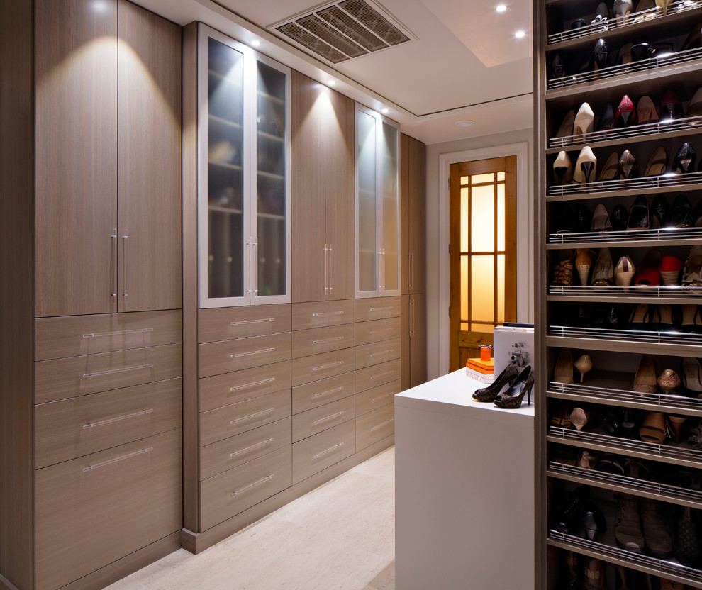 Design ideas for a contemporary storage and wardrobe in New Orleans with medium wood cabinets.