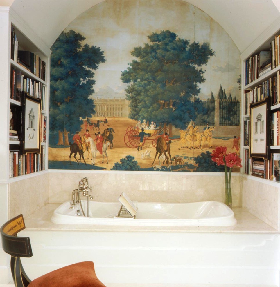 This is an example of a traditional bathroom in DC Metro with a drop-in tub and beige tile.