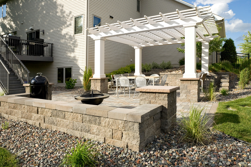 Mid-sized transitional backyard patio in Minneapolis with concrete pavers, a fire feature and a pergola.