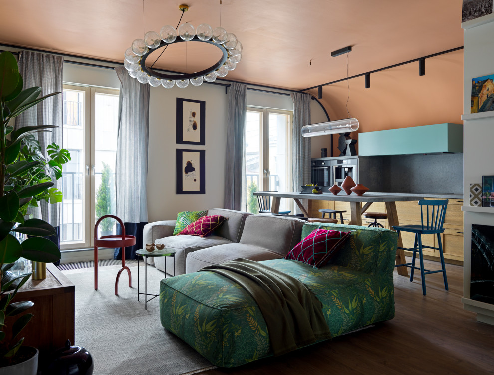 На фото: парадная, объединенная гостиная комната среднего размера в стиле фьюжн с разноцветными стенами, полом из ламината, телевизором на стене, зоной отдыха и коричневым полом