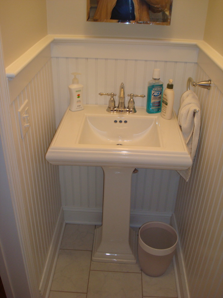 This is an example of a small traditional kids bathroom in New York with an alcove tub, a shower/bathtub combo, a two-piece toilet, multi-coloured tile, beige walls, ceramic floors and a pedestal sink.