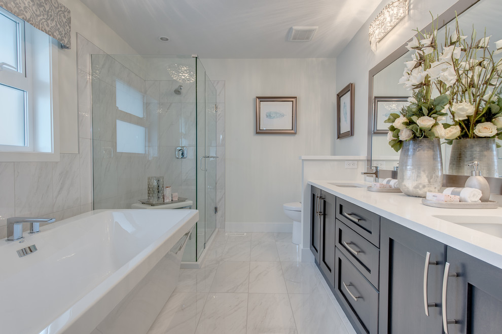 Inspiration for a contemporary master bathroom in Vancouver with shaker cabinets, a freestanding tub and a corner shower.