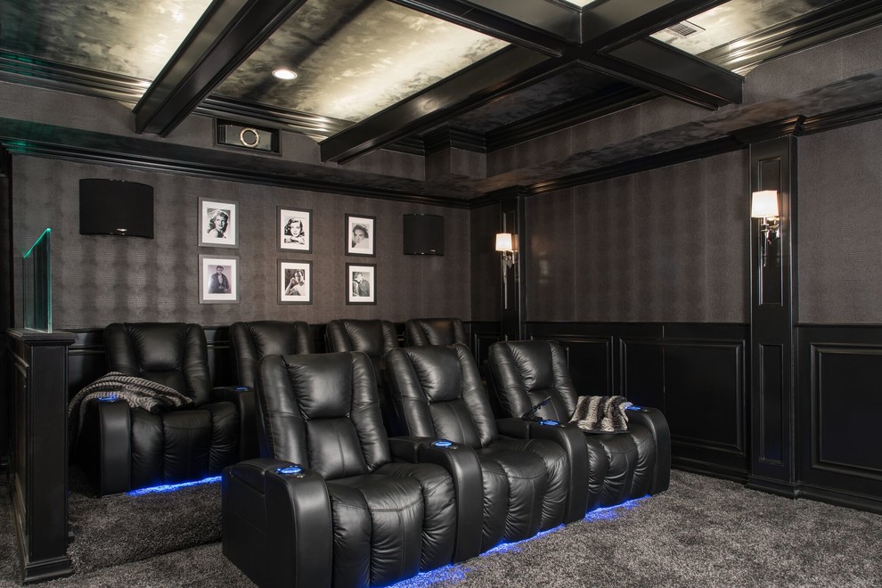 Large traditional enclosed home theatre in St Louis with grey walls, carpet and a projector screen.