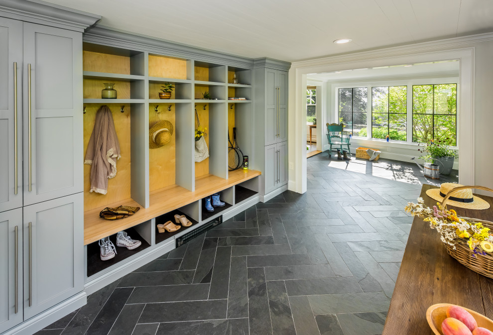 Design ideas for a large transitional mudroom in Providence with white walls, slate floors, grey floor and timber.