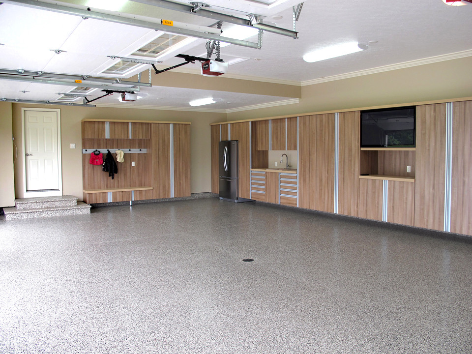 Mid-sized minimalist attached three-car garage workshop photo in Cleveland