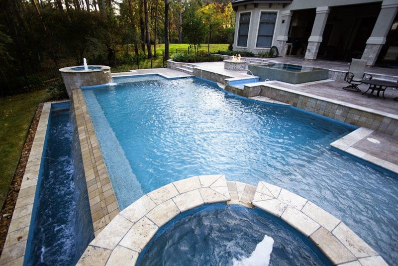 Pool - large backyard brick and custom-shaped natural pool idea in Austin