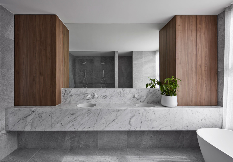 Design ideas for a contemporary master bathroom in Melbourne with grey cabinets, a freestanding tub, an open shower, grey walls, ceramic floors, engineered quartz benchtops, grey floor, an open shower and a double vanity.