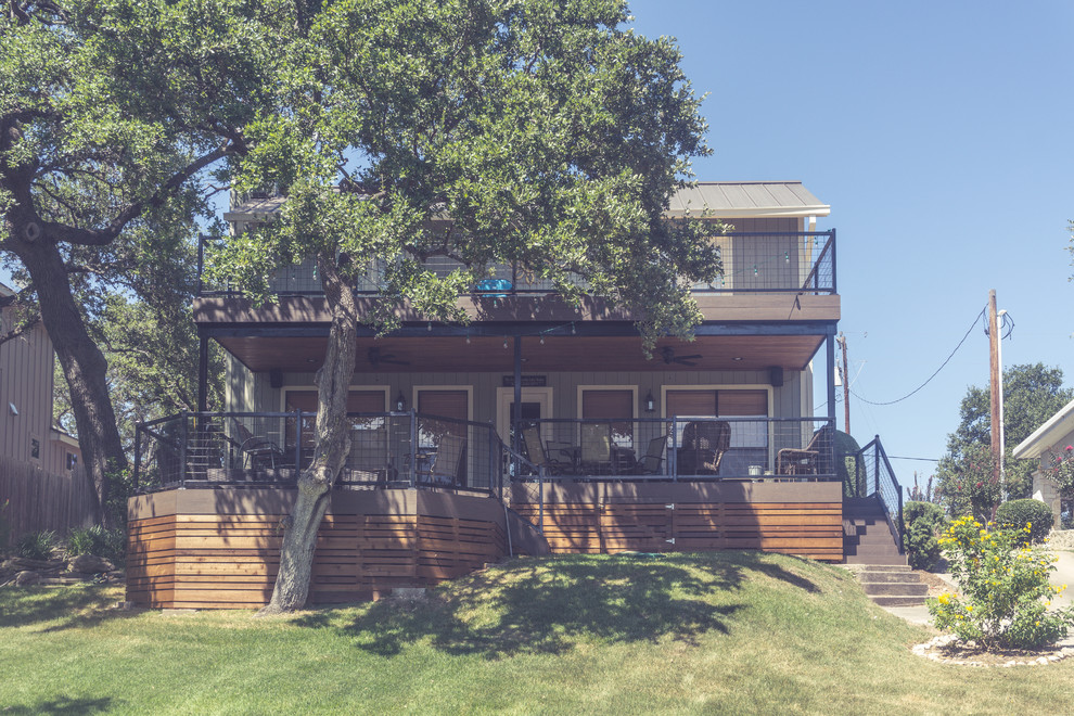 Example of a large mountain style backyard balcony deck design in Austin