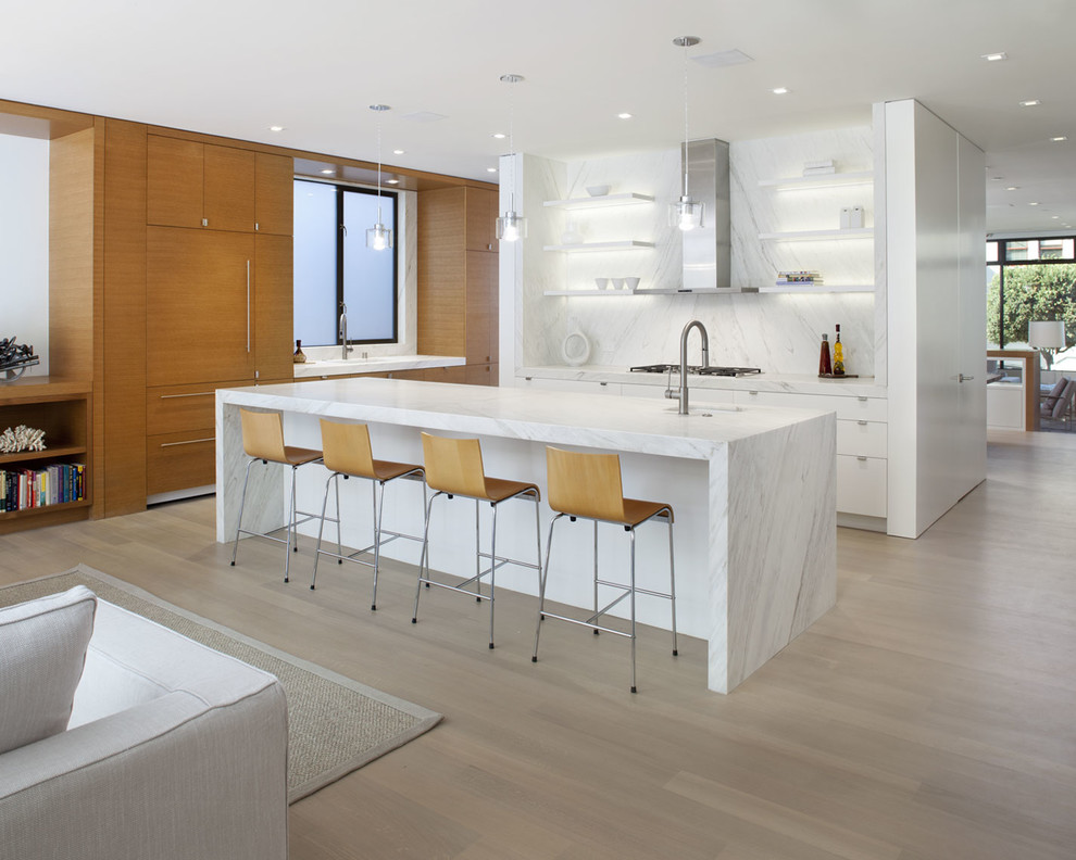 Design ideas for a mid-sized contemporary u-shaped open plan kitchen in San Francisco with an undermount sink, flat-panel cabinets, white cabinets, marble benchtops, white splashback, stone slab splashback, panelled appliances and with island.