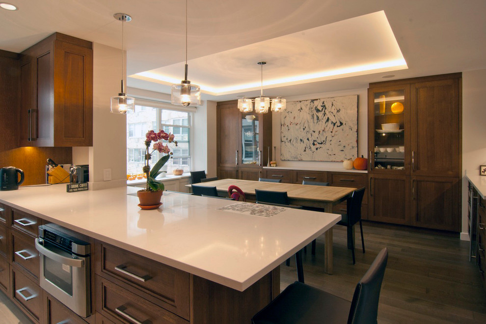 Photo of a mid-sized modern u-shaped eat-in kitchen in New York with medium wood cabinets, white splashback, stainless steel appliances, light hardwood floors and a peninsula.