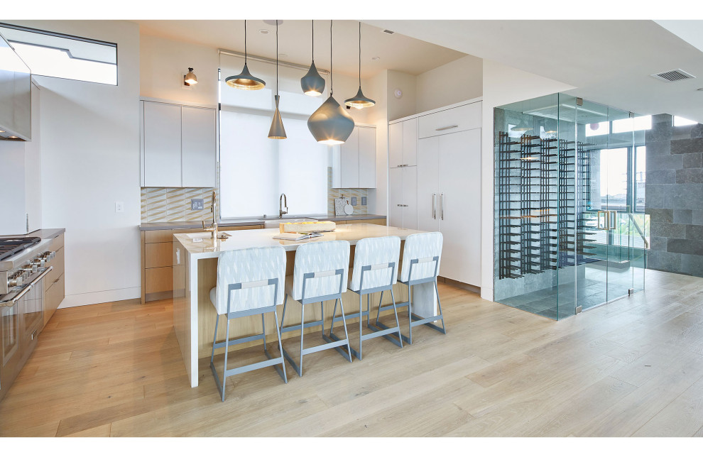 This is an example of a small contemporary wine cellar in Los Angeles with light hardwood floors, display racks and beige floor.