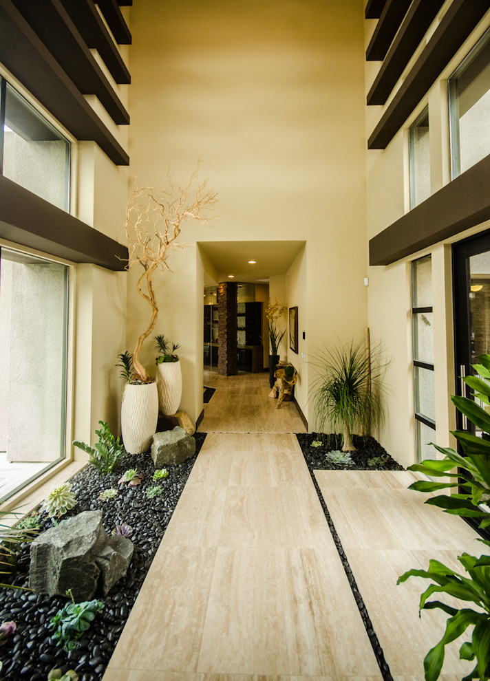 Photo of a large contemporary hallway in Las Vegas with beige walls and beige floor.
