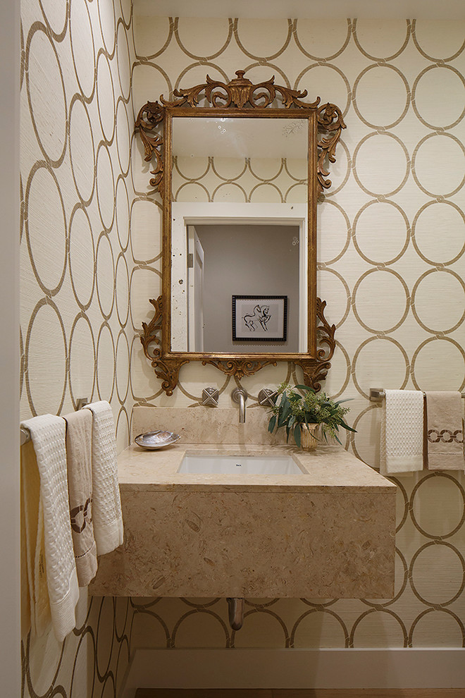 Inspiration for a small transitional powder room in San Francisco with an undermount sink, limestone benchtops, beige tile and multi-coloured walls.