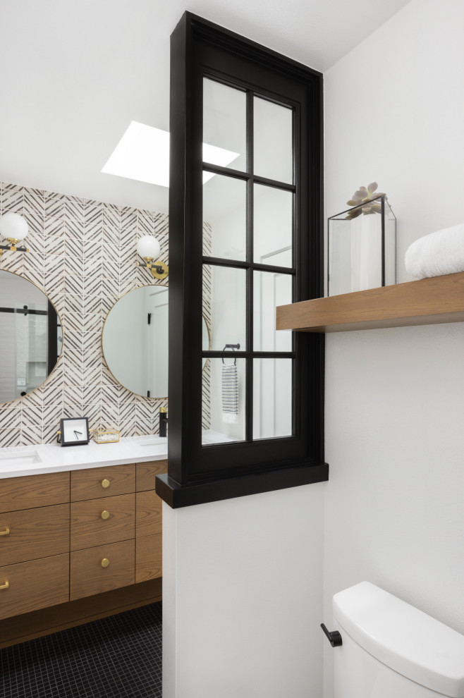 This is an example of a mid-sized modern master bathroom in Portland with flat-panel cabinets, light wood cabinets, a curbless shower, a one-piece toilet, black and white tile, ceramic tile, white walls, ceramic floors, an undermount sink, engineered quartz benchtops, black floor, a sliding shower screen, white benchtops, a double vanity and a floating vanity.