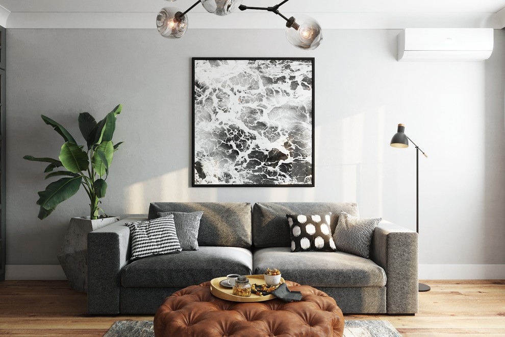 Для отдыха в гостиной подобрали лаконичный диван и стёганый пуф-столик, на ко