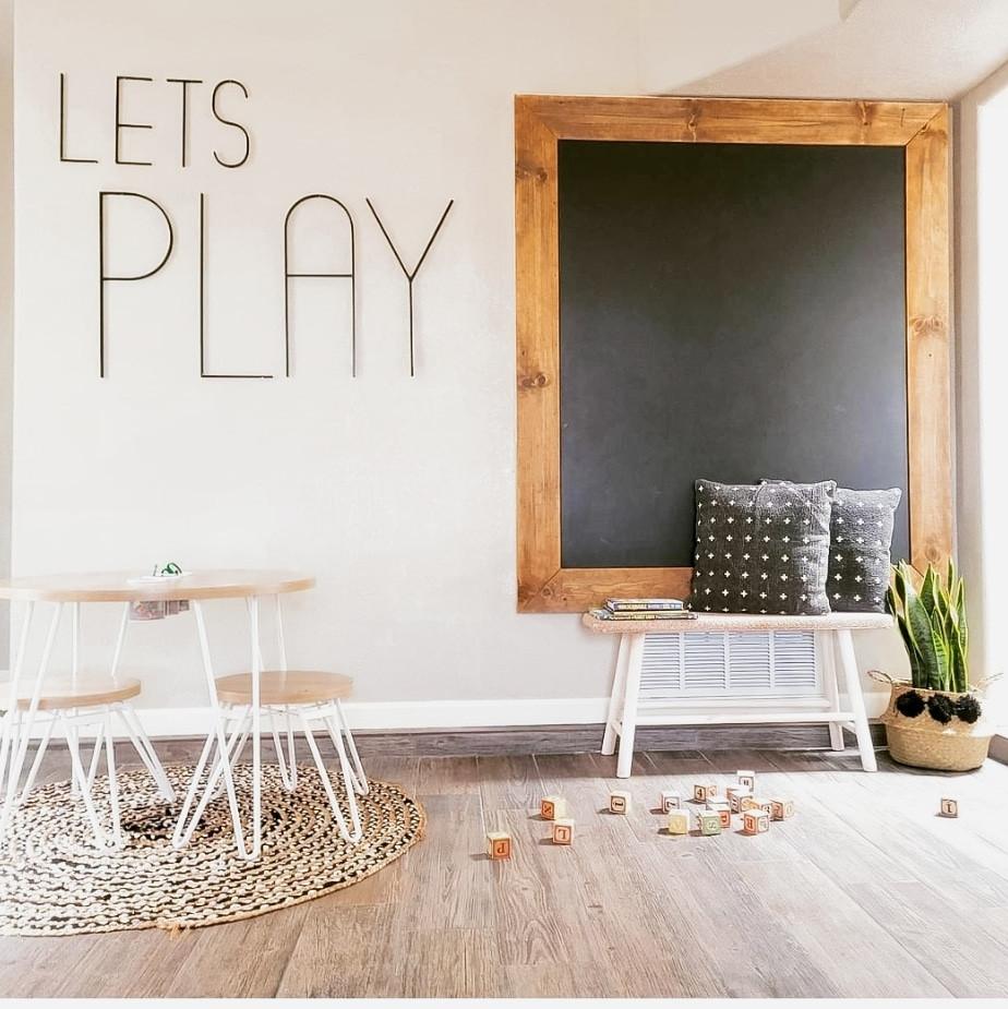 Huge minimalist medium tone wood floor and brown floor playroom photo in Albuquerque