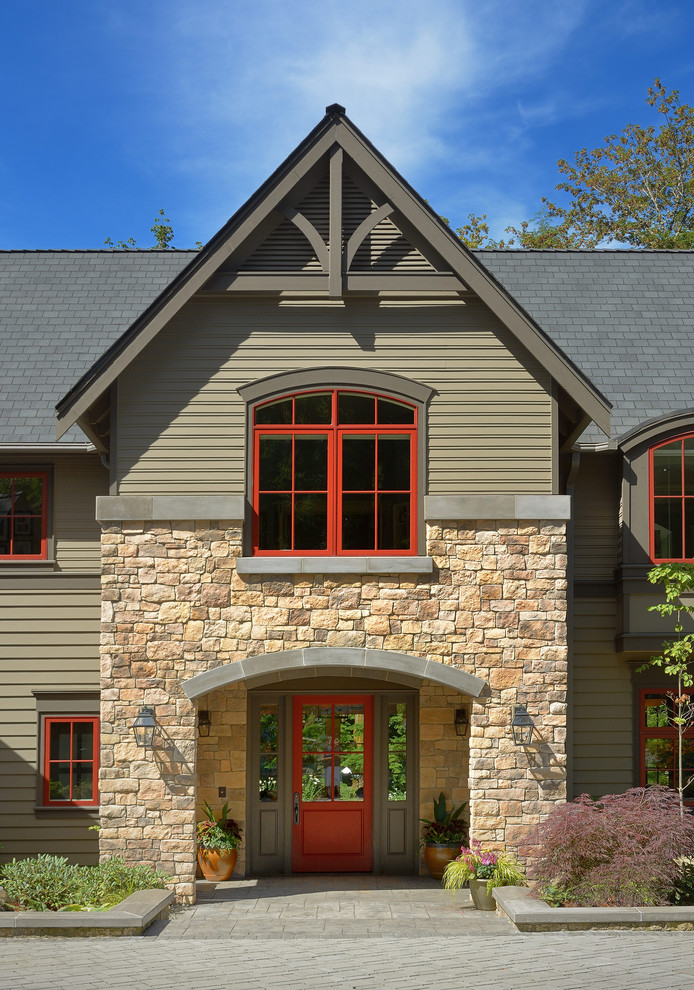 Transitional exterior in Seattle with stone veneer and a gable roof.