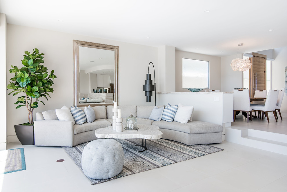 Inspiration for a beach style open concept living room in San Diego with white walls and white floor.