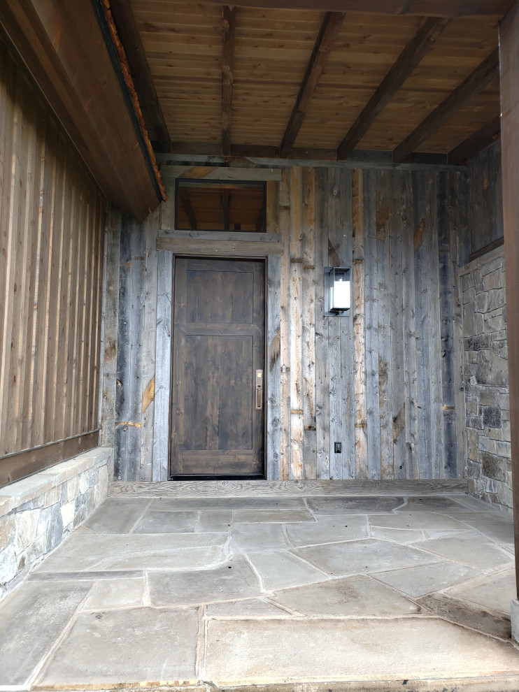 Inspiration for a mid-sized rustic gray floor front door remodel with a dark wood front door
