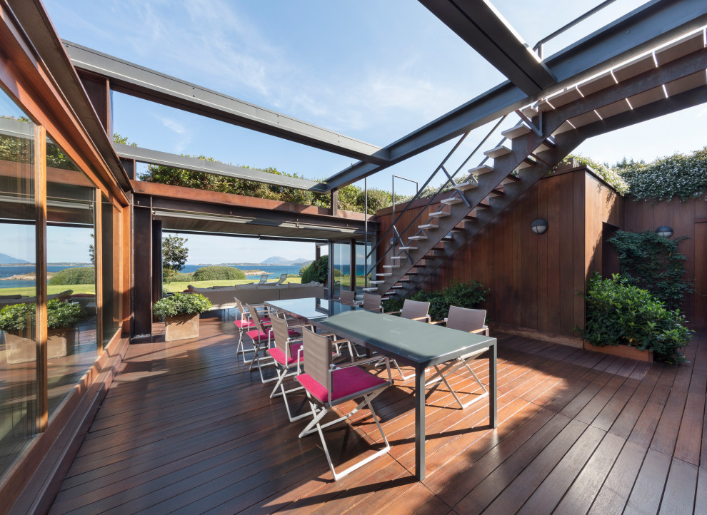 Expansive modern deck in Cagliari with an outdoor kitchen.