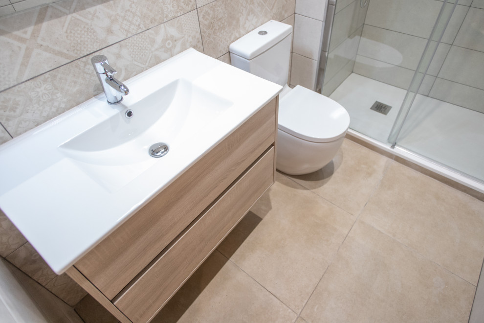 Design ideas for a medium sized contemporary ensuite bathroom in Barcelona with flat-panel cabinets, medium wood cabinets, a built-in shower, a one-piece toilet, beige tiles, ceramic tiles, ceramic flooring, a trough sink, beige floors, a sliding door, white worktops, an enclosed toilet, a single sink and a floating vanity unit.