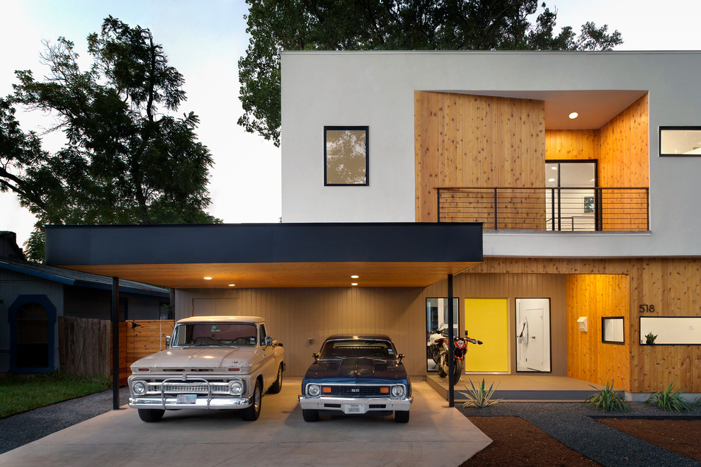 Inspiration for a contemporary two-storey house exterior in Austin with a flat roof and mixed siding.
