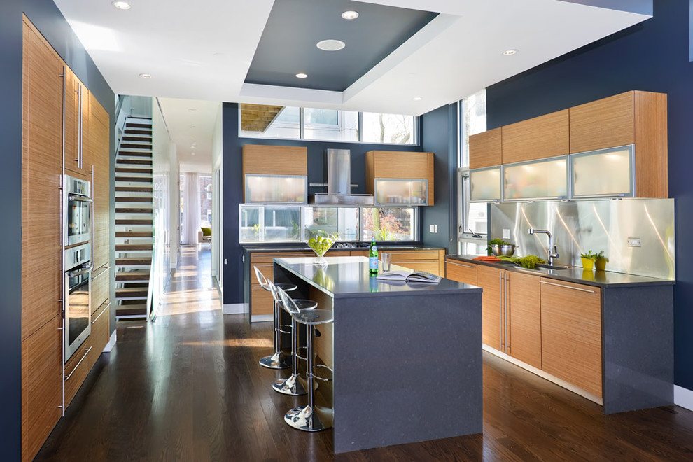Design ideas for a modern u-shaped kitchen in Chicago with flat-panel cabinets, light wood cabinets and blue benchtop.