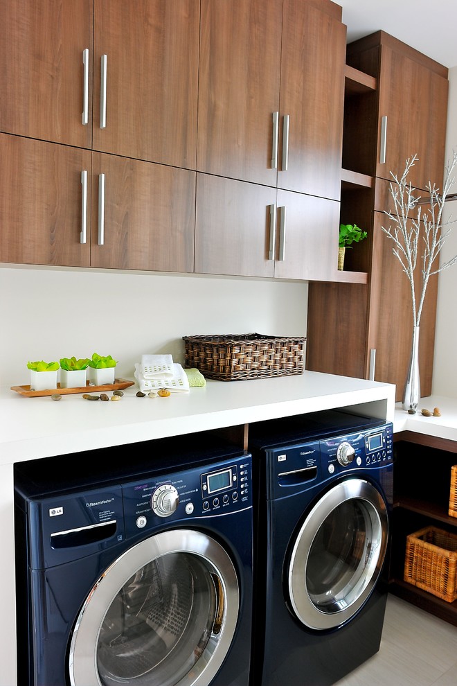 Inspiration for a contemporary laundry room in Montreal with flat-panel cabinets, medium wood cabinets and a side-by-side washer and dryer.