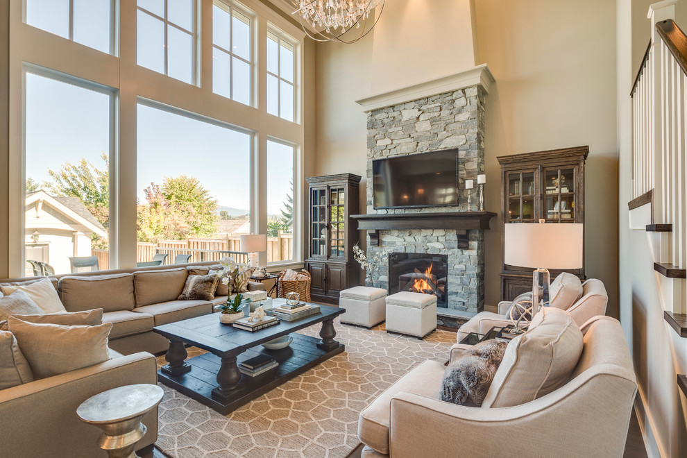 Inspiration for a mid-sized traditional open concept living room in Vancouver with beige walls, dark hardwood floors, a standard fireplace, a stone fireplace surround and a wall-mounted tv.