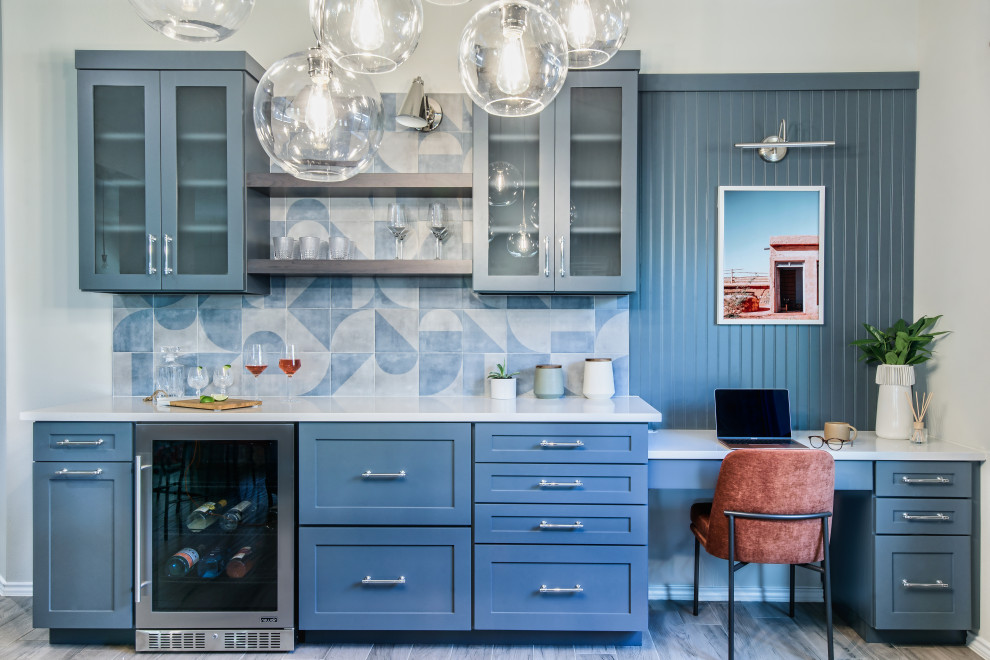 Mid-sized modern home bar in Austin with shaker cabinets, blue cabinets, quartzite benchtops, blue splashback, ceramic splashback, ceramic floors, brown floor and white benchtop.