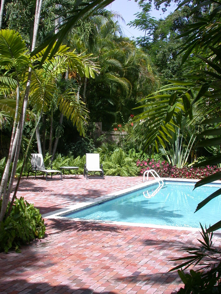 Design ideas for a traditional pool in Miami with brick pavers.