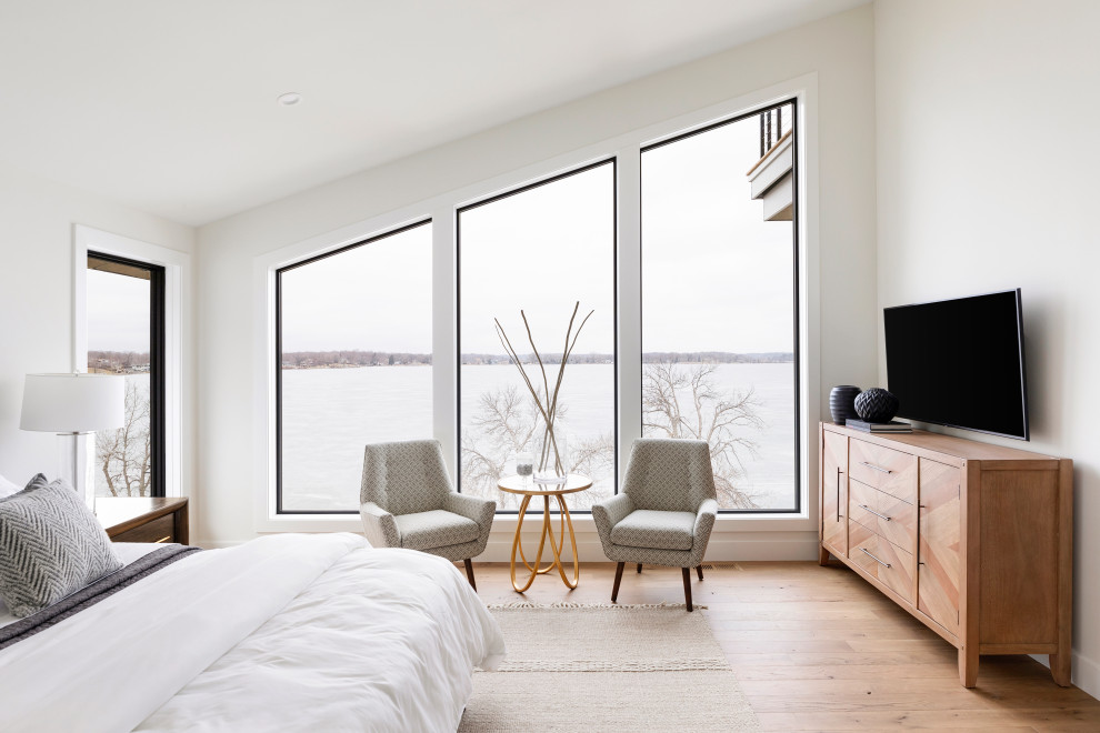 Inspiration for a contemporary bedroom in Minneapolis with white walls, medium hardwood floors, brown floor and vaulted.