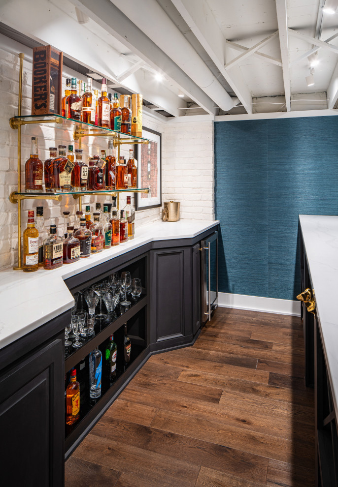 This is an example of a mid-sized modern fully buried basement in Columbus with white walls, vinyl floors, brown floor and wood walls.