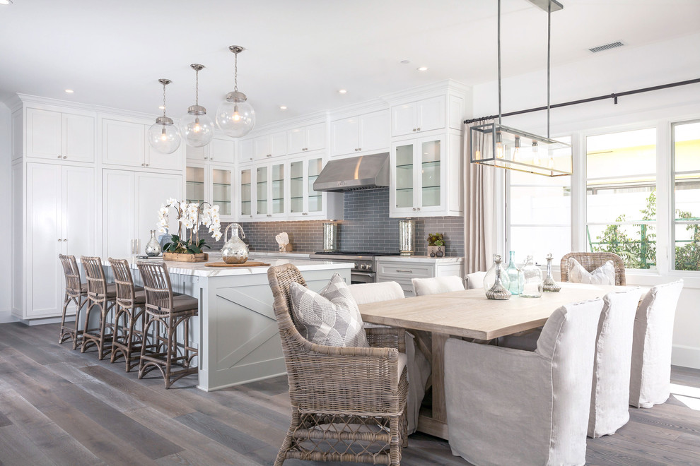 Photo of a beach style kitchen/dining combo in Orange County with white walls and dark hardwood floors.
