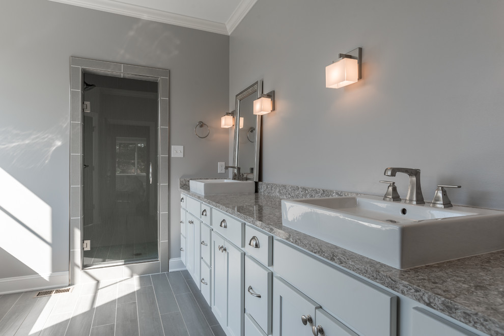 Alcove shower - mid-sized transitional master gray tile and subway tile porcelain tile alcove shower idea with shaker cabinets, white cabinets, gray walls and a vessel sink