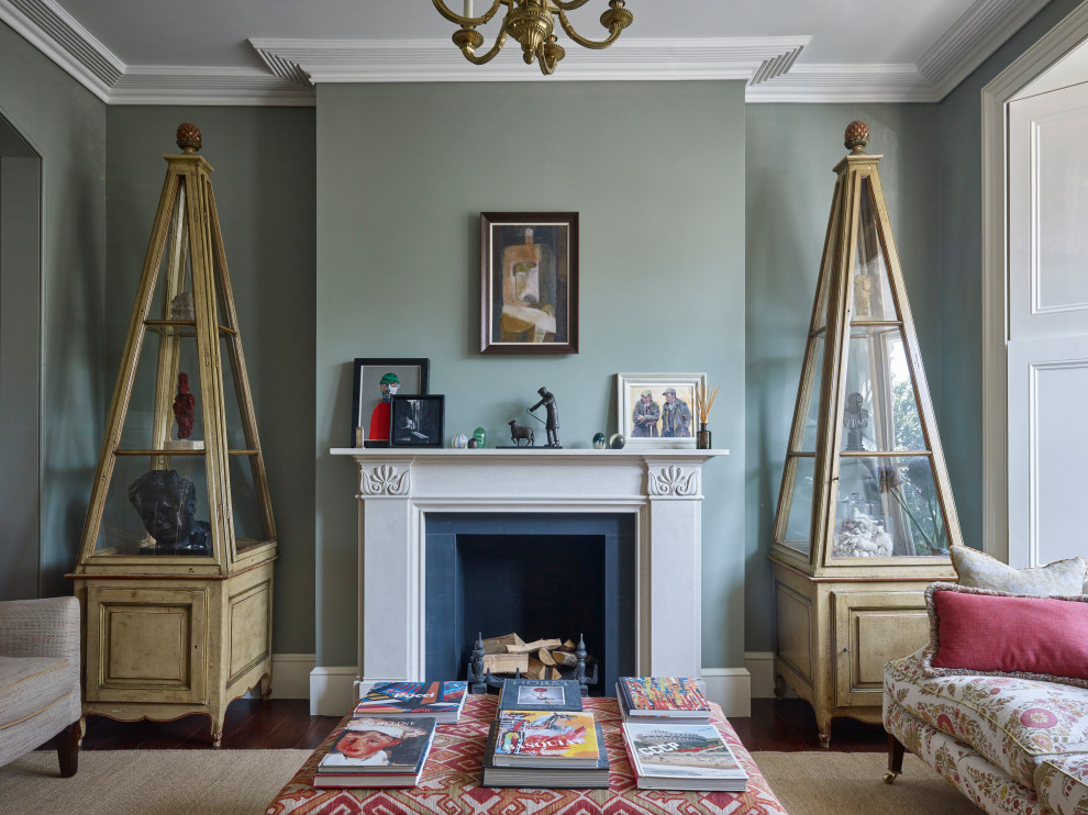 Photo of a medium sized victorian enclosed living room in London with a reading nook, green walls, medium hardwood flooring, a standard fireplace and no tv.