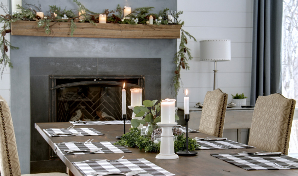 Cette image montre une salle à manger avec un mur blanc, une cheminée standard, un manteau de cheminée en béton et du lambris de bois.
