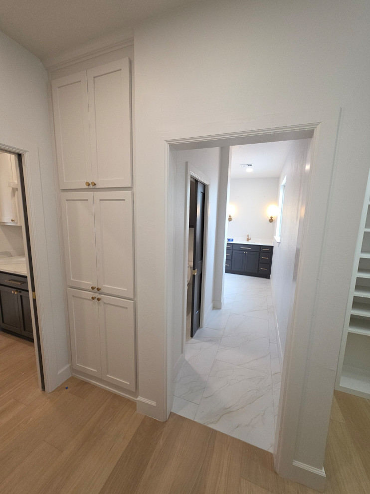 Primary/Master Closet Storage with pocket doors to laundry room