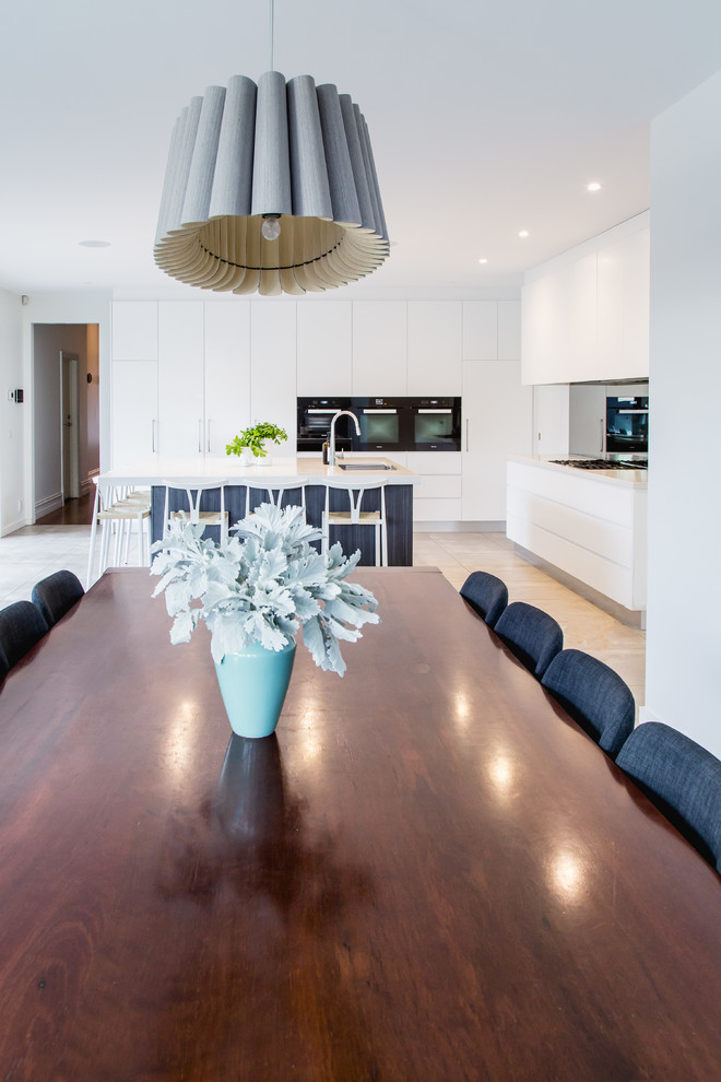 Photo of a large contemporary kitchen/dining combo in Melbourne with white walls and porcelain floors.