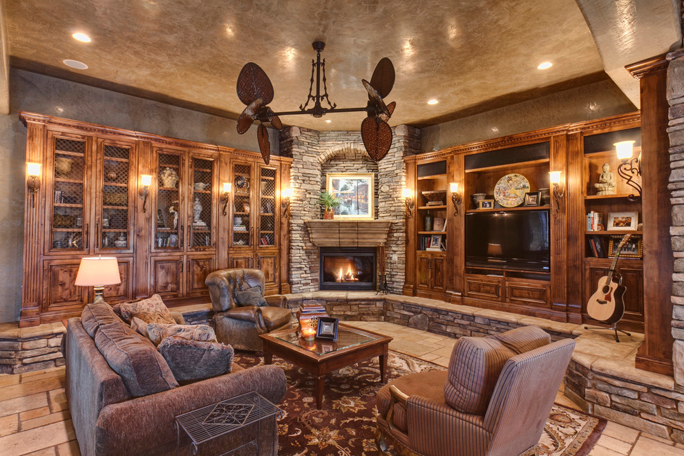 Mediterranean living room in Other with a corner fireplace and a stone fireplace surround.
