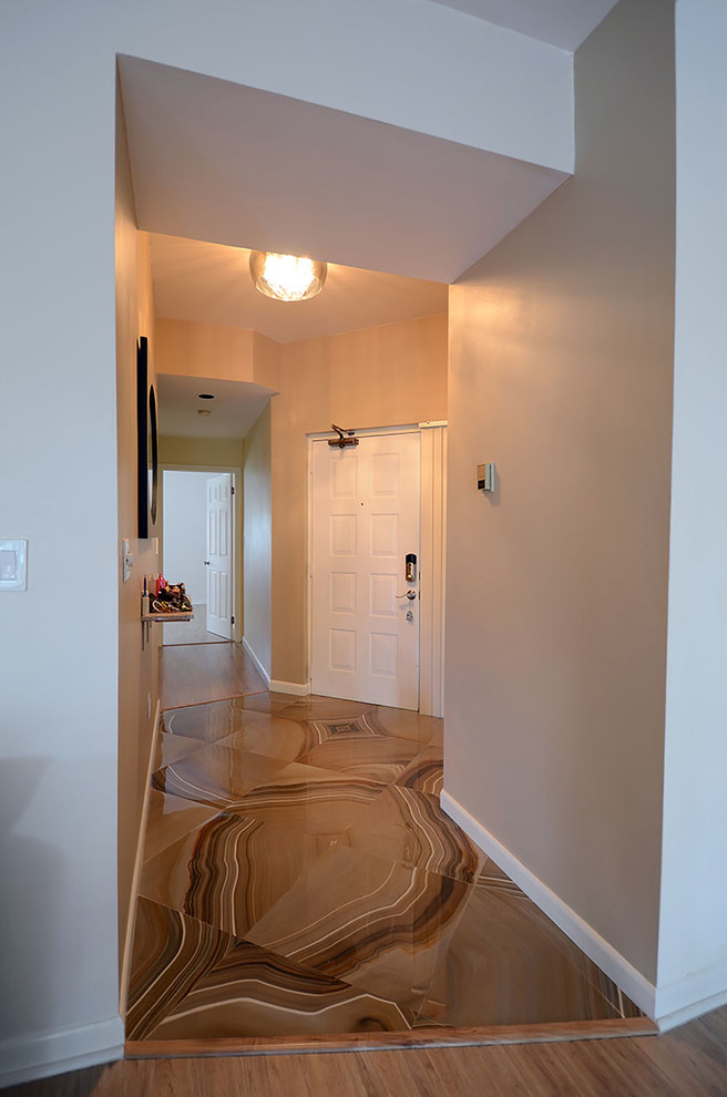 This is an example of a mid-sized modern foyer in Miami with brown walls and porcelain floors.