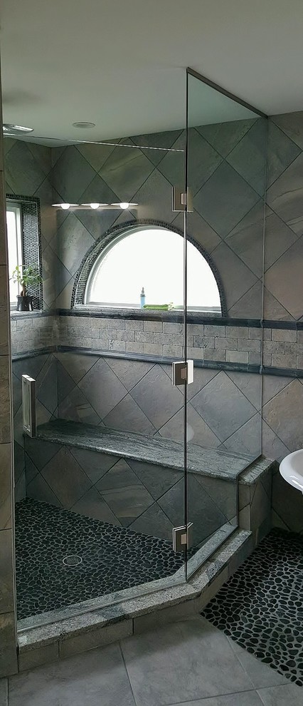This is an example of a contemporary bathroom in Miami with a corner shower and a hinged shower door.
